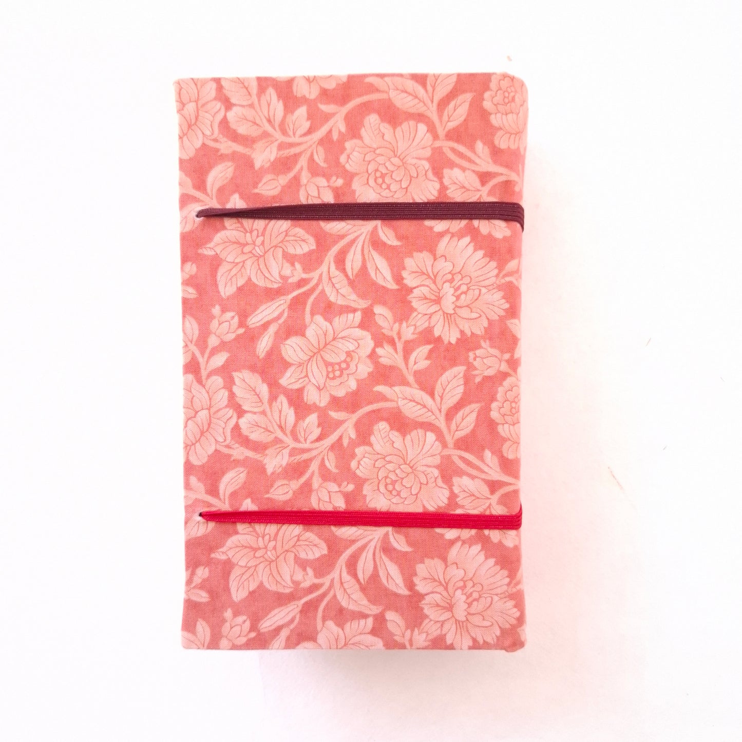 Pressa per fiori da viaggio foderata in tessuto con fiori rosa e corallo